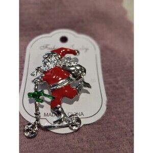 New Santa on Scooter Brooch. 2ins Long, 1ins Wide.